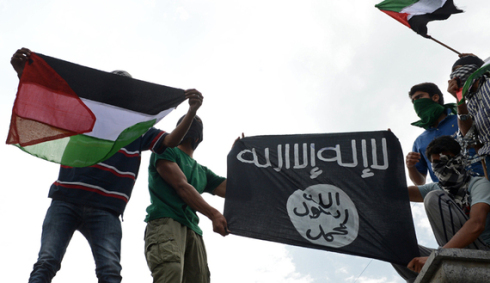 Kashmiri demonstrators hold up Palestinian flags and a flag of the Islamic State of Iraq and the Levant (ISIL) during a demonstration against Israeli military operations in Gaza, in downtown Srinagar on July 18, 2014. The death toll in Gaza hit 265 as Israel pressed a ground offensive on the 11th day of an assault aimed at stamping out rocket fire, medics said. AFP PHOTO/Tauseef MUSTAFA (Photo credit should read TAUSEEF MUSTAFA/AFP/Getty Images)